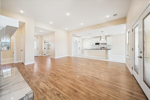 unfurnished living room featuring light hardwood / wood-style flooring