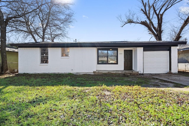 single story home with a garage and a front lawn