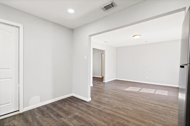 spare room featuring dark wood-type flooring