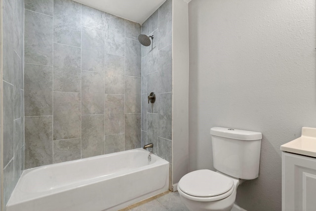 full bathroom with tiled shower / bath, tile patterned floors, vanity, and toilet