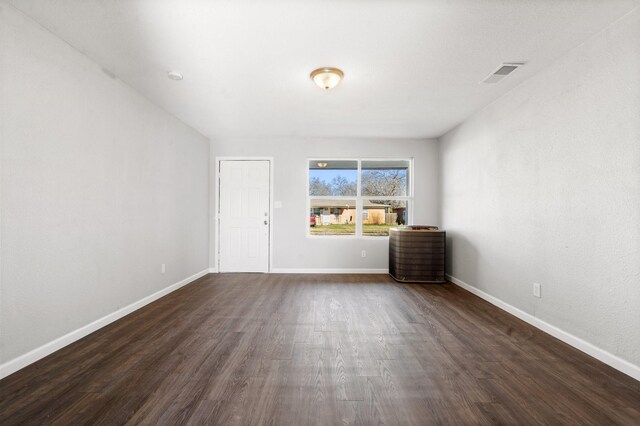 empty room featuring dark wood-type flooring