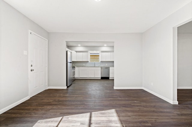 unfurnished living room with dark wood-type flooring and sink