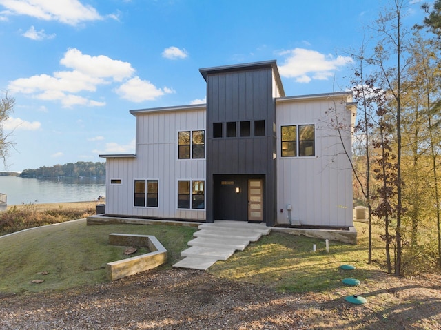 view of front facade featuring a front yard and a water view