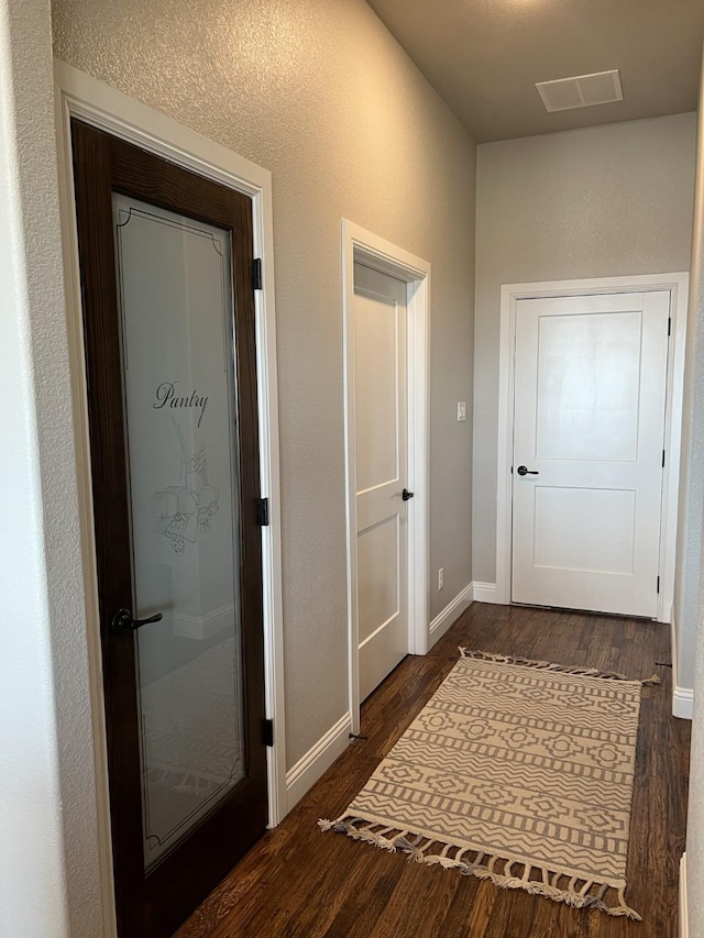 hall with dark hardwood / wood-style floors