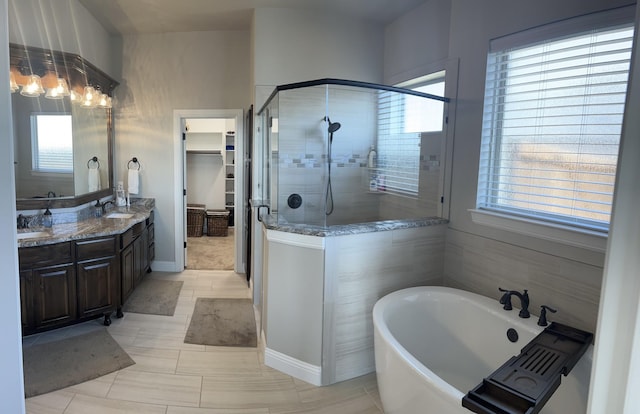 bathroom with plus walk in shower, vanity, and tile patterned flooring