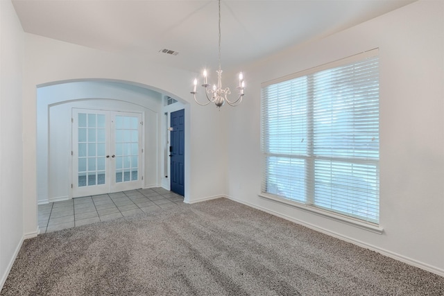 unfurnished room with french doors, light colored carpet, and a notable chandelier