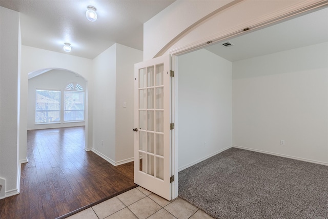 hall featuring light tile patterned floors