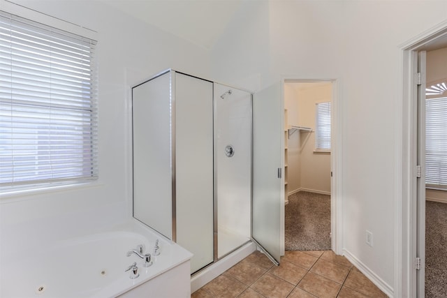 bathroom featuring tile patterned floors and independent shower and bath