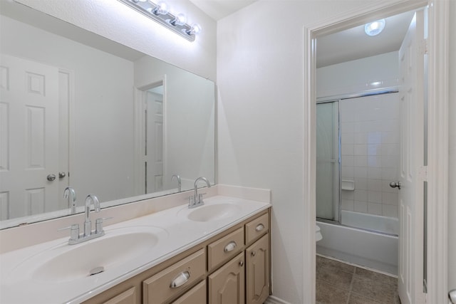 bathroom with shower / bath combination with glass door and vanity