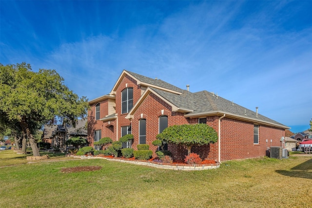 view of front of house featuring a front yard and central AC unit