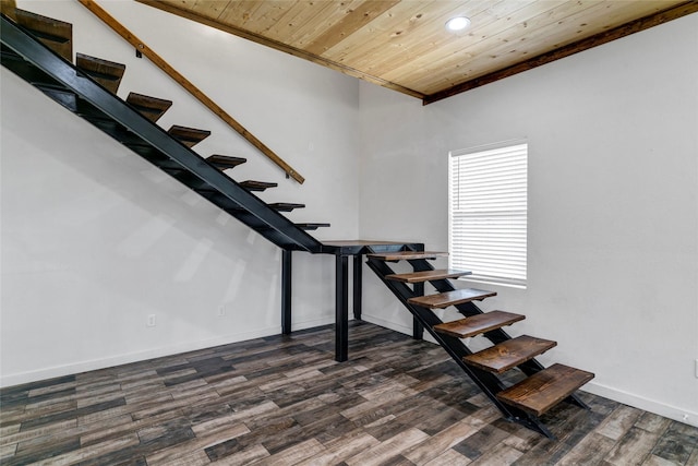 stairs featuring hardwood / wood-style flooring and wooden ceiling