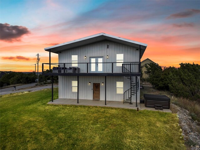 rear view of house featuring a patio, a yard, and a deck