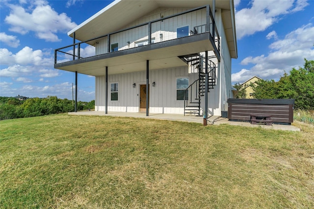 rear view of property featuring a patio area and a yard