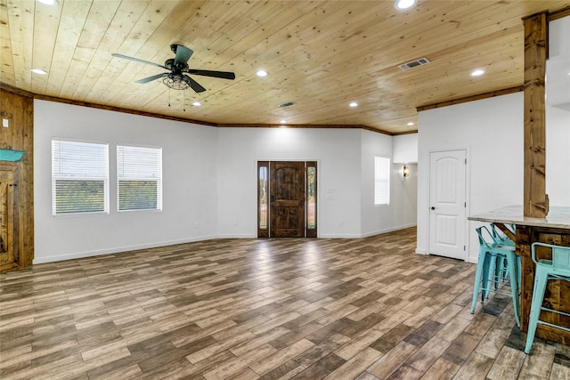 unfurnished living room featuring a healthy amount of sunlight, ceiling fan, wood ceiling, and hardwood / wood-style flooring