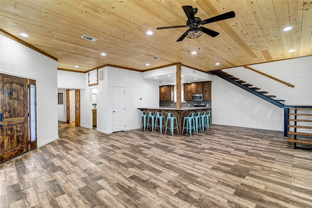 unfurnished living room with ceiling fan, crown molding, wooden ceiling, and wood-type flooring