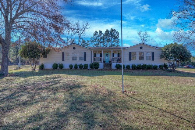 ranch-style house featuring a front lawn and a porch