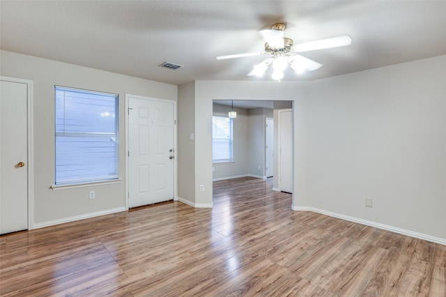 unfurnished room with ceiling fan and light hardwood / wood-style flooring