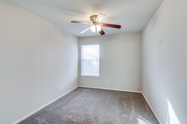 carpeted empty room featuring ceiling fan and baseboards