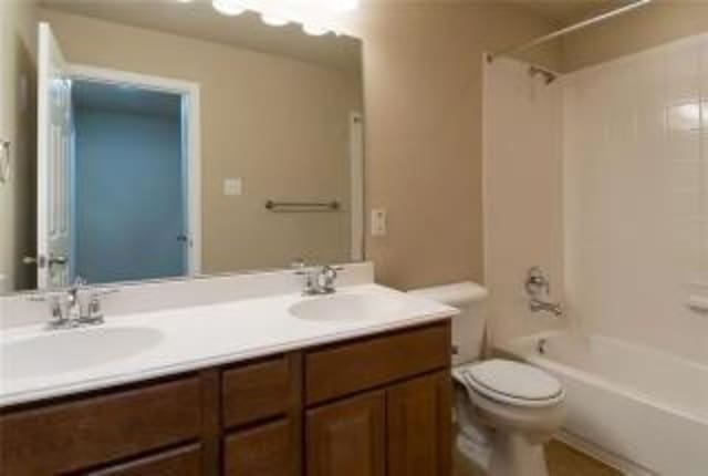 full bathroom featuring shower / bath combination, vanity, and toilet