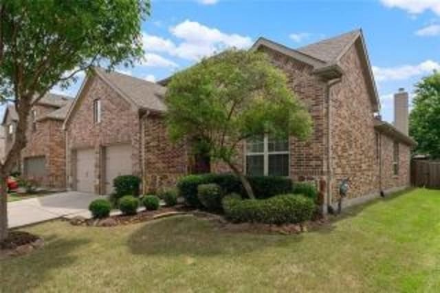 front facade with a garage and a front yard