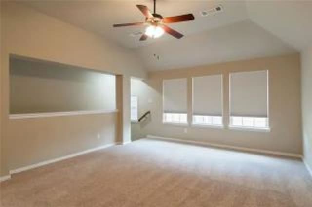 bonus room featuring ceiling fan, lofted ceiling, and light colored carpet