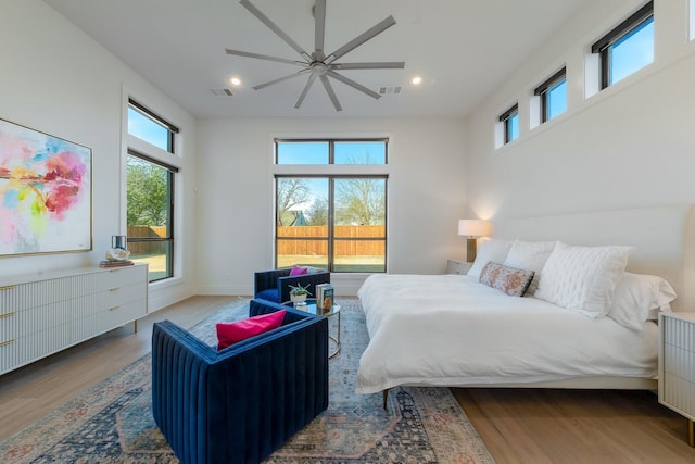 bedroom featuring multiple windows, wood finished floors, and visible vents