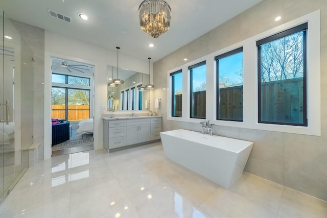 bathroom with vanity, visible vents, a freestanding tub, a shower stall, and ensuite bathroom