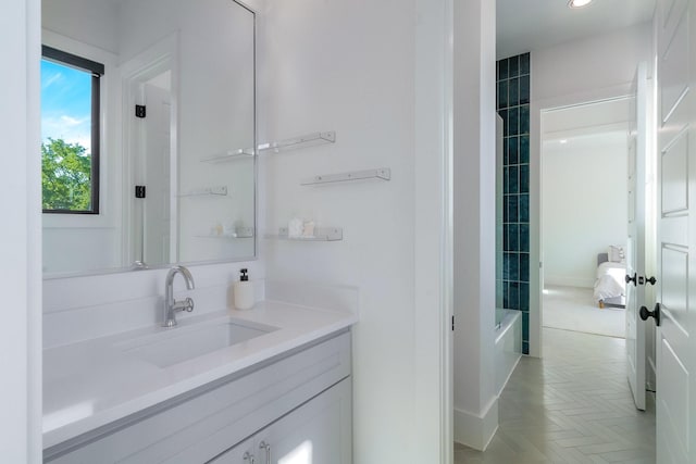 bathroom with vanity and parquet flooring