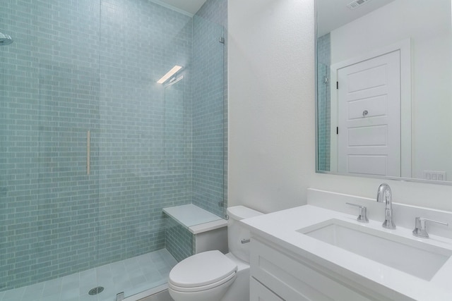 full bath with visible vents, tiled shower, toilet, and vanity