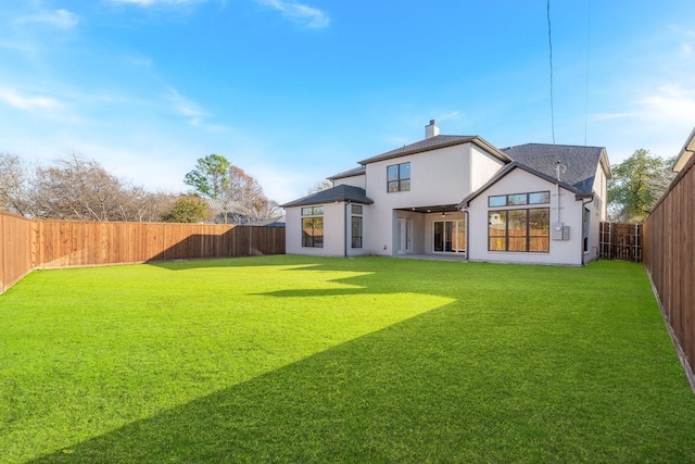 back of house featuring a yard