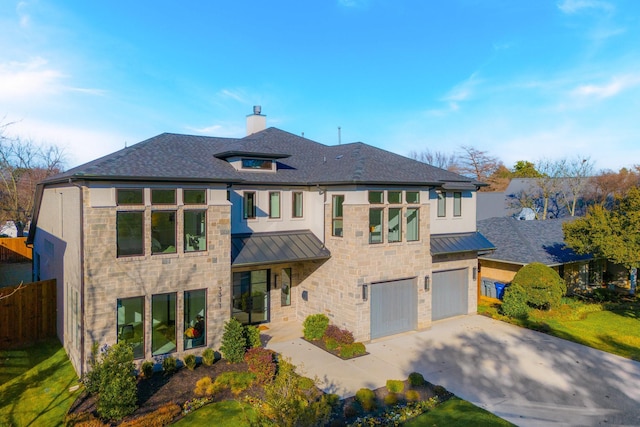 view of front of property featuring metal roof, driveway, and a standing seam roof