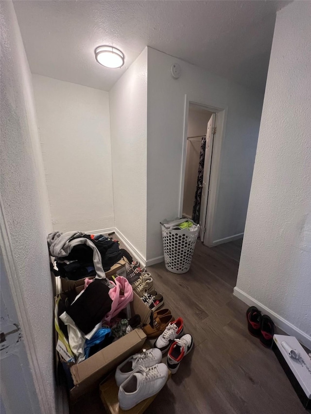 misc room featuring dark hardwood / wood-style flooring and a textured ceiling