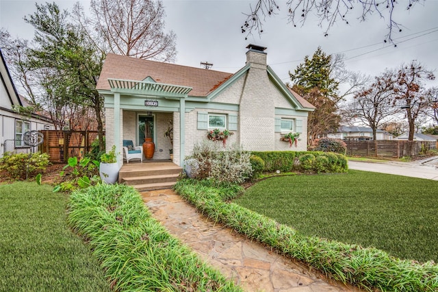 view of front of property with covered porch and a front yard