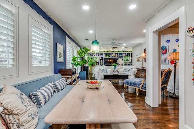 dining area with dark hardwood / wood-style floors, ceiling fan, and crown molding