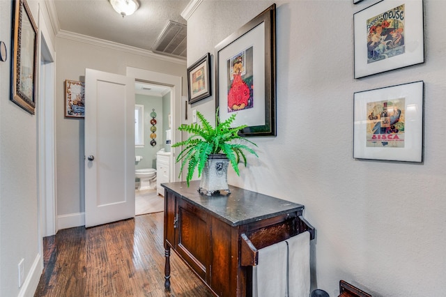 hallway featuring dark hardwood / wood-style floors and crown molding