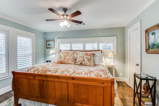 bedroom with hardwood / wood-style floors, ceiling fan, and crown molding