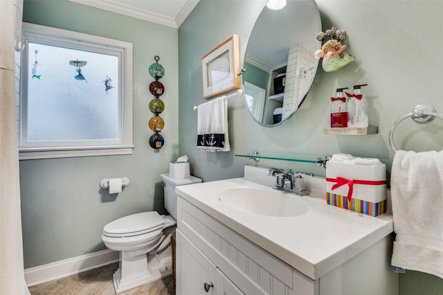 bathroom with a wealth of natural light, toilet, vanity, and ornamental molding