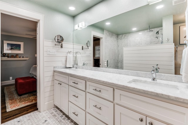 bathroom featuring tiled shower, vanity, tile patterned floors, and ornamental molding