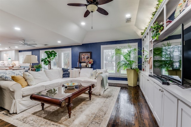 living room with dark hardwood / wood-style flooring, vaulted ceiling, and ceiling fan