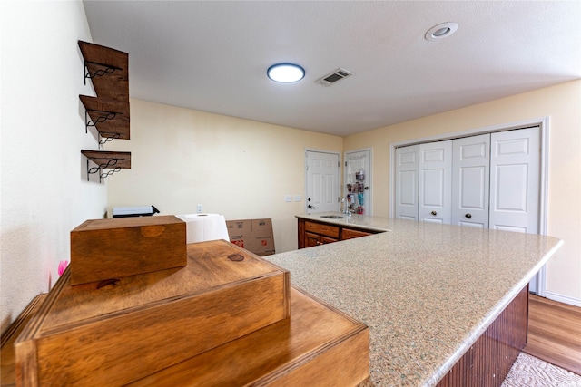 kitchen with sink and light hardwood / wood-style flooring