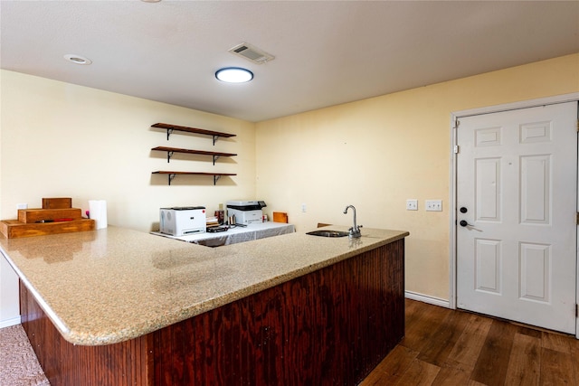 kitchen with dark hardwood / wood-style flooring, sink, and kitchen peninsula