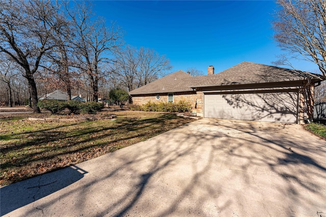 view of home's exterior featuring a garage and a lawn