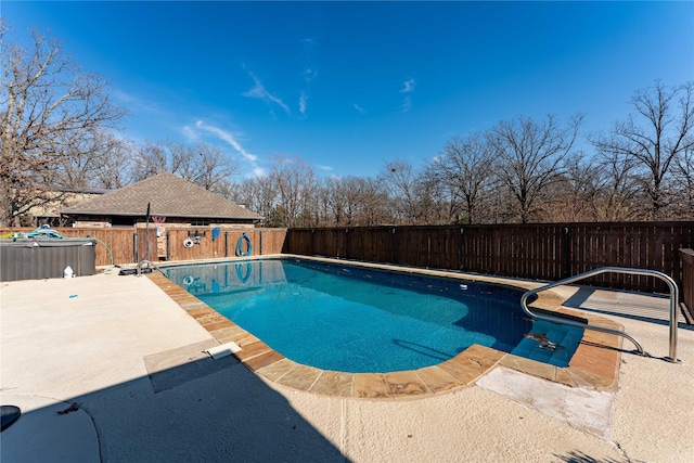 view of pool with a jacuzzi and a patio area