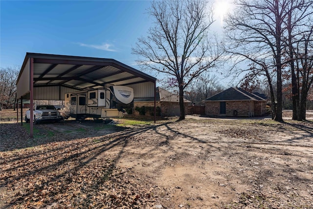 rear view of property with a carport