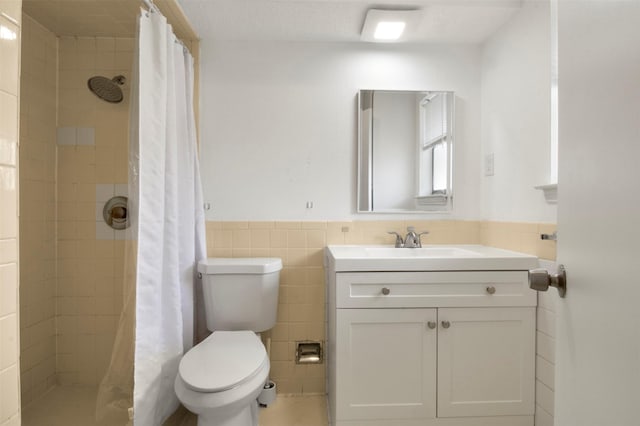 bathroom with a shower with shower curtain, vanity, toilet, and tile walls