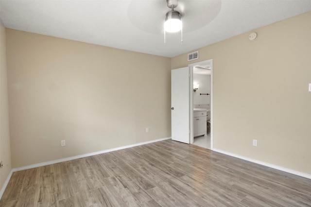 spare room with ceiling fan and light hardwood / wood-style flooring