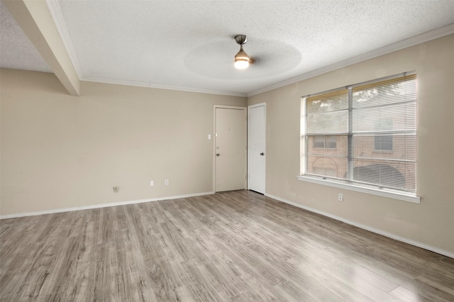 empty room with ceiling fan, light hardwood / wood-style flooring, and ornamental molding