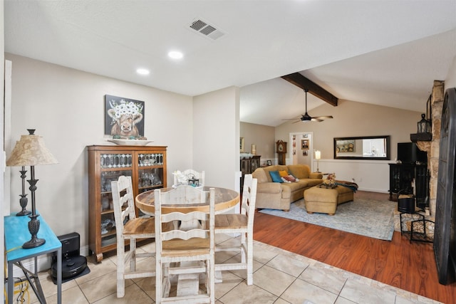 dining area featuring light tile patterned floors, vaulted ceiling with beams, and ceiling fan