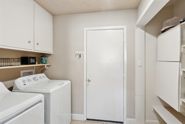 laundry area with washer and clothes dryer and cabinets