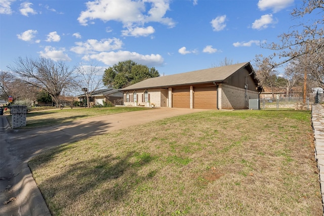 view of front of home featuring central AC, a front yard, and a garage